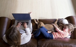 Family on couch with laptop