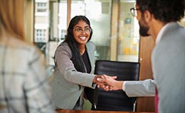 Spouse shaking hands with professionals