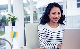 Woman seated at desk using laptop
