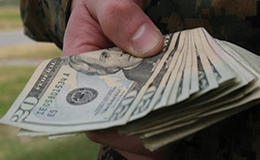 Hand holding a stack of cash