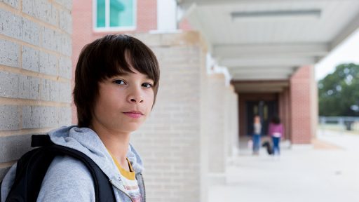 Teen boy outside school