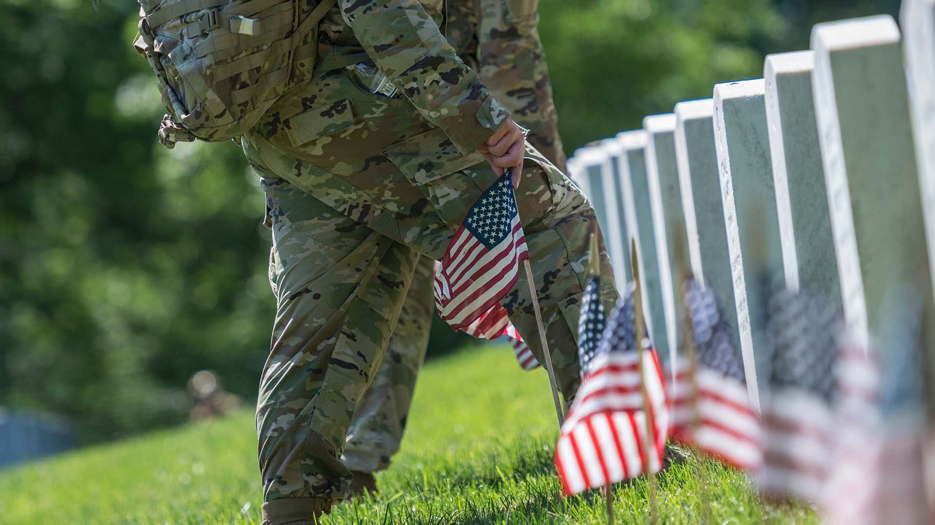 service members place flags on memorial day