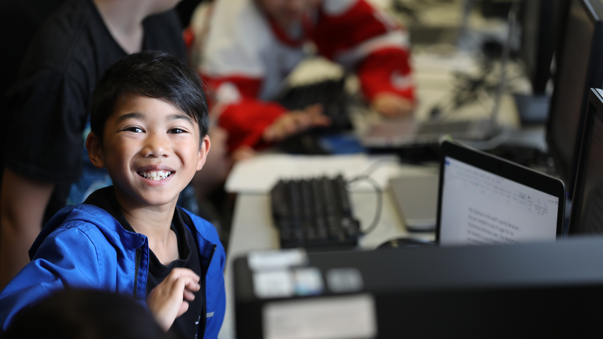 Young boy learning on a computer