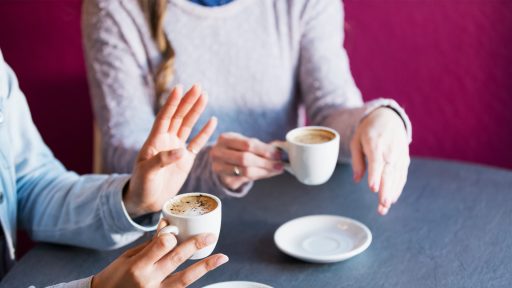 Two friends chat over coffee