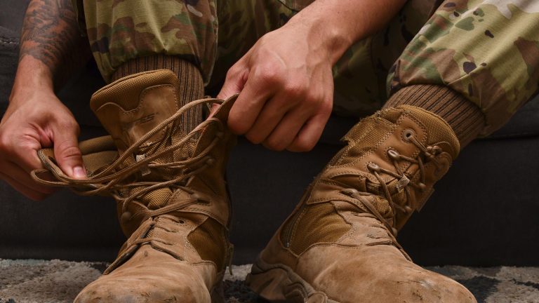 Service member tying boots