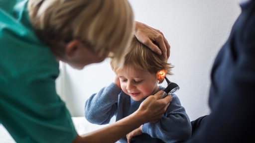 Child being examined by otoscope