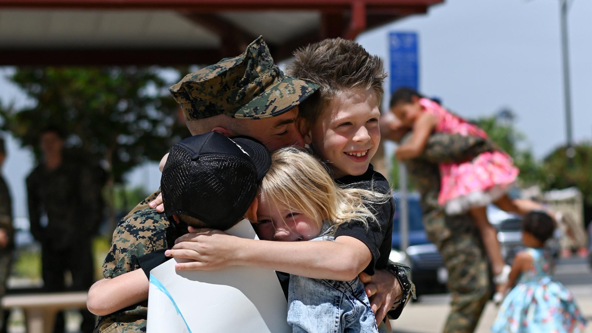 Father greeting his children after deployment