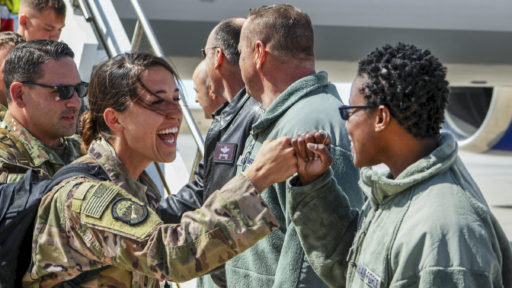 Service members giving each other a high-five handshake