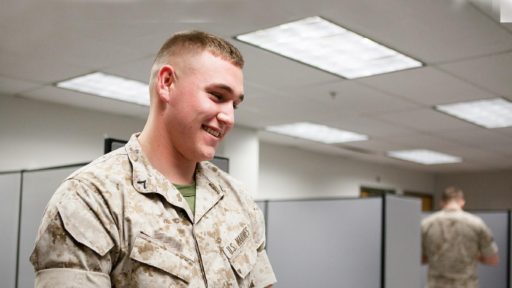 A marine talks with staff at a tax assistance center.