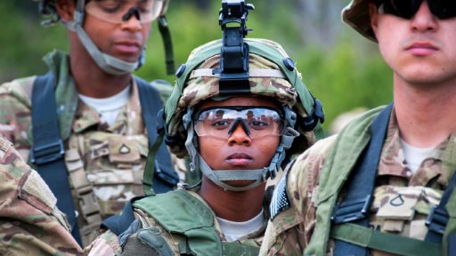Service member with ballistic glasses looks into the distance