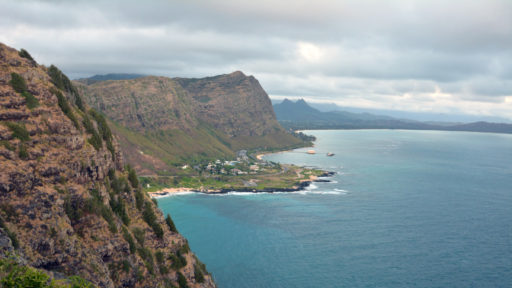 Scenic view of tropical cliff surrounded by ocean.