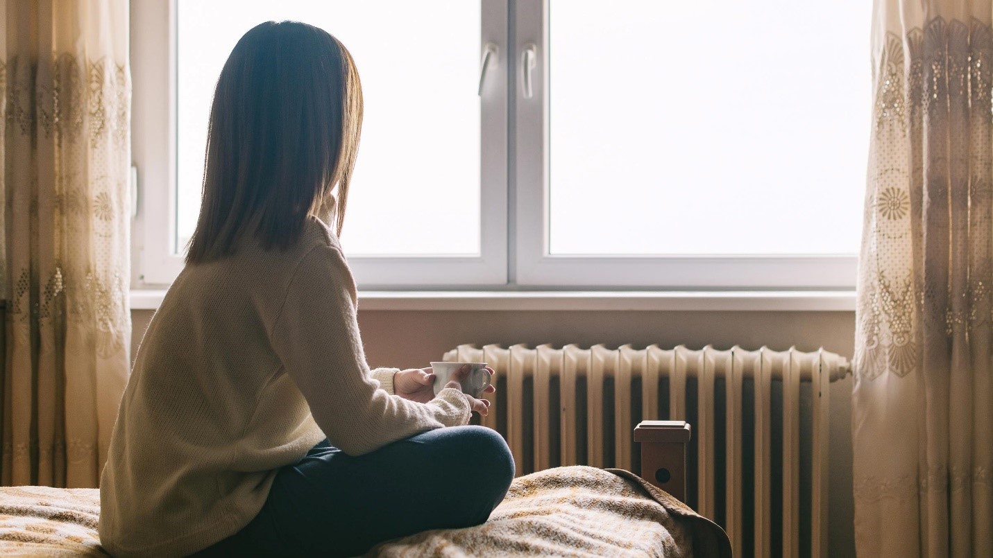 woman looking out window