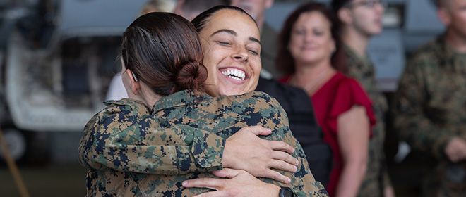 Marine service members hugging