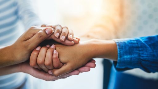 Several women holding hands.