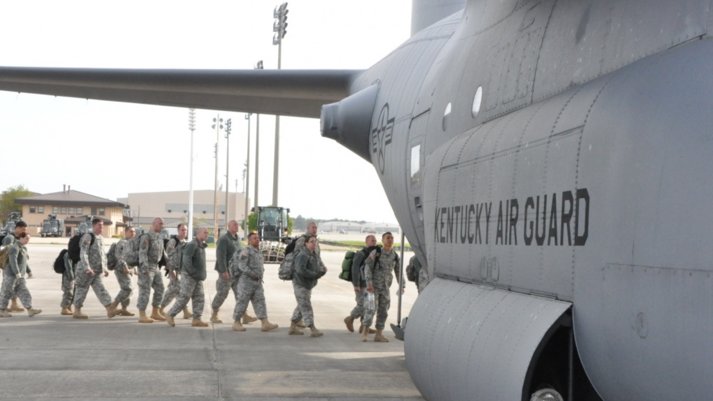 A group of National Guard soldiers board a military cargo plan after an exercise.