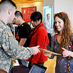Woman handing a package to a service member