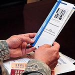 Service member holding pamphlet