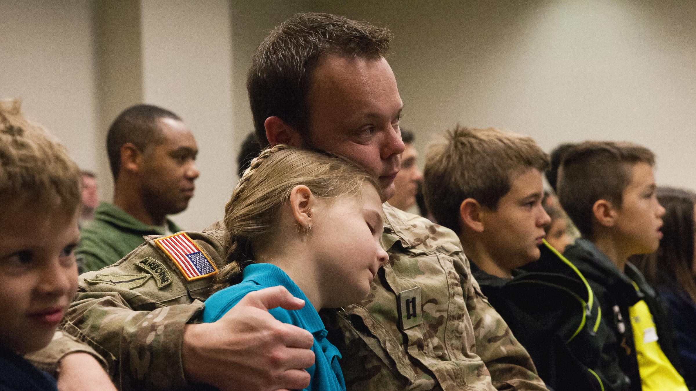 Service member hugging daughter