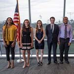 Students standing in front of a Flag