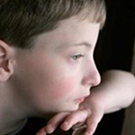 boy resting head on hand