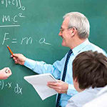 Teacher pointing at a chalkboard