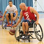 A service member playing basketball in a wheelchair