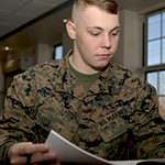 service member reading brochure