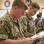 Service members looking at documents