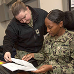 service members looking over papers