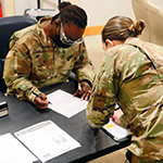 soldier looking at paperwork in office