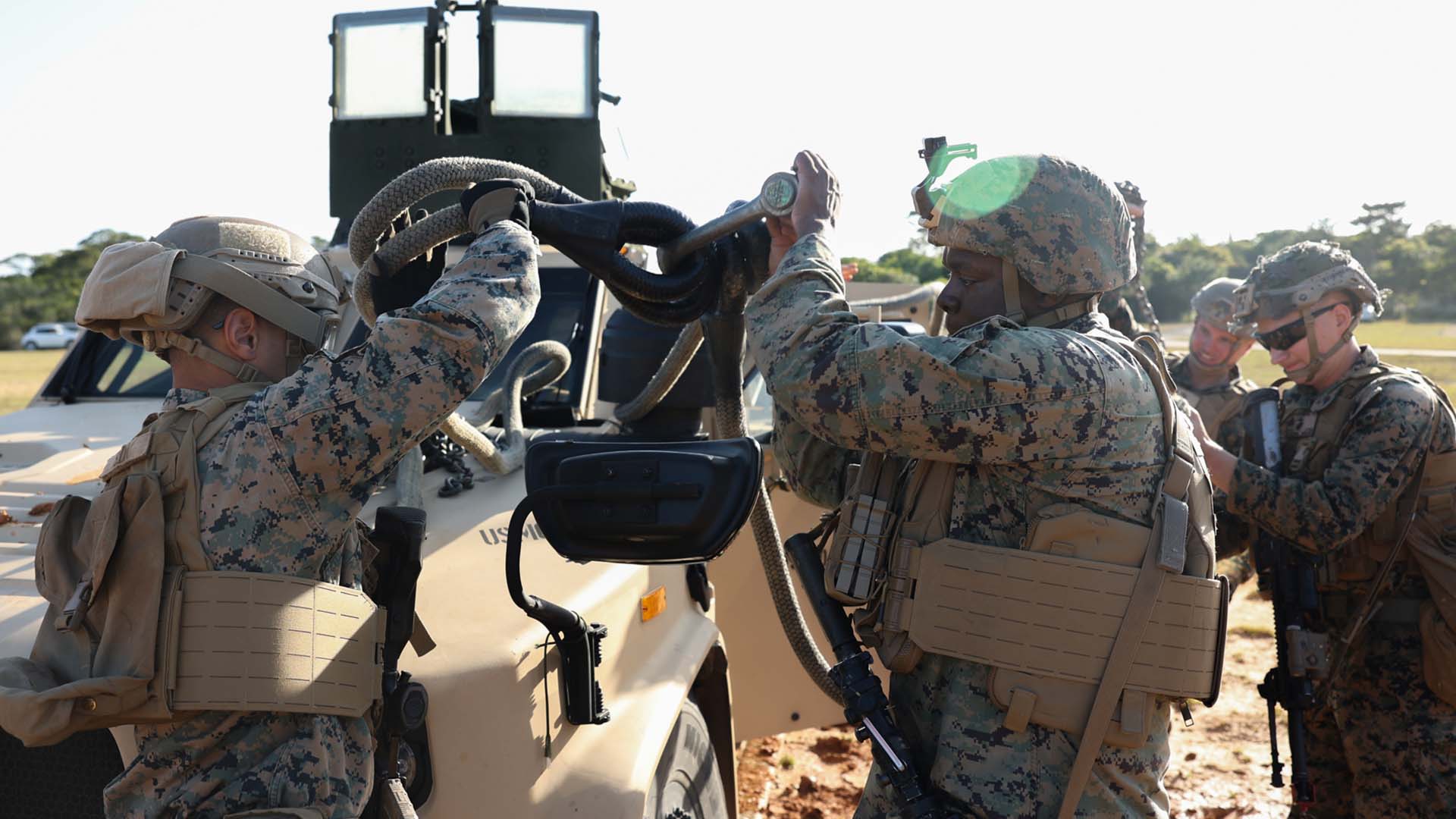 service members prepare vehicle for transport