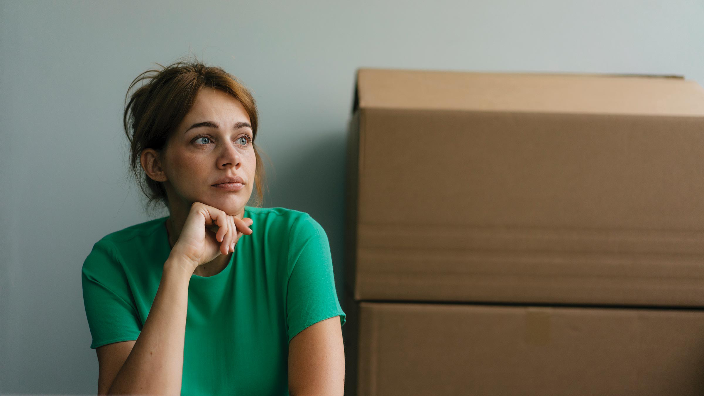 Woman sitting with moving boxes