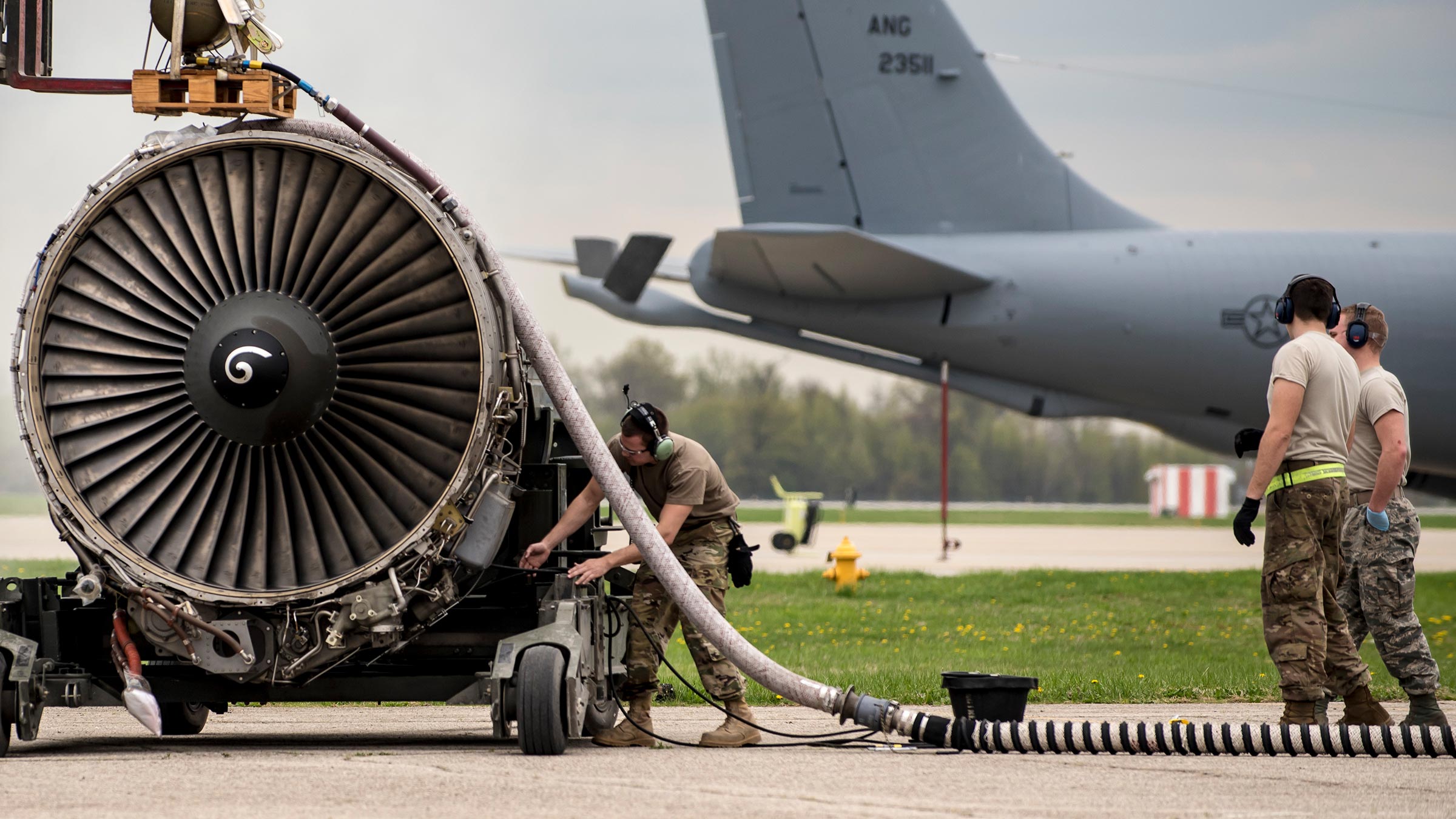 Airmen prepare an engine for shipment.
