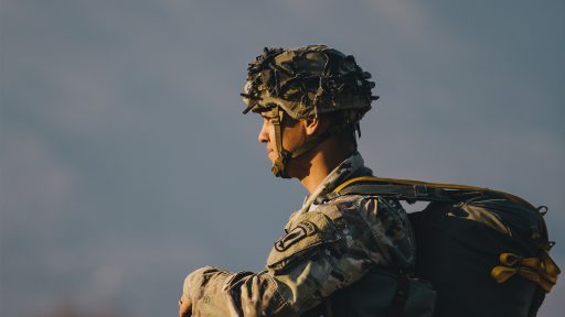 Service member looking into sunset