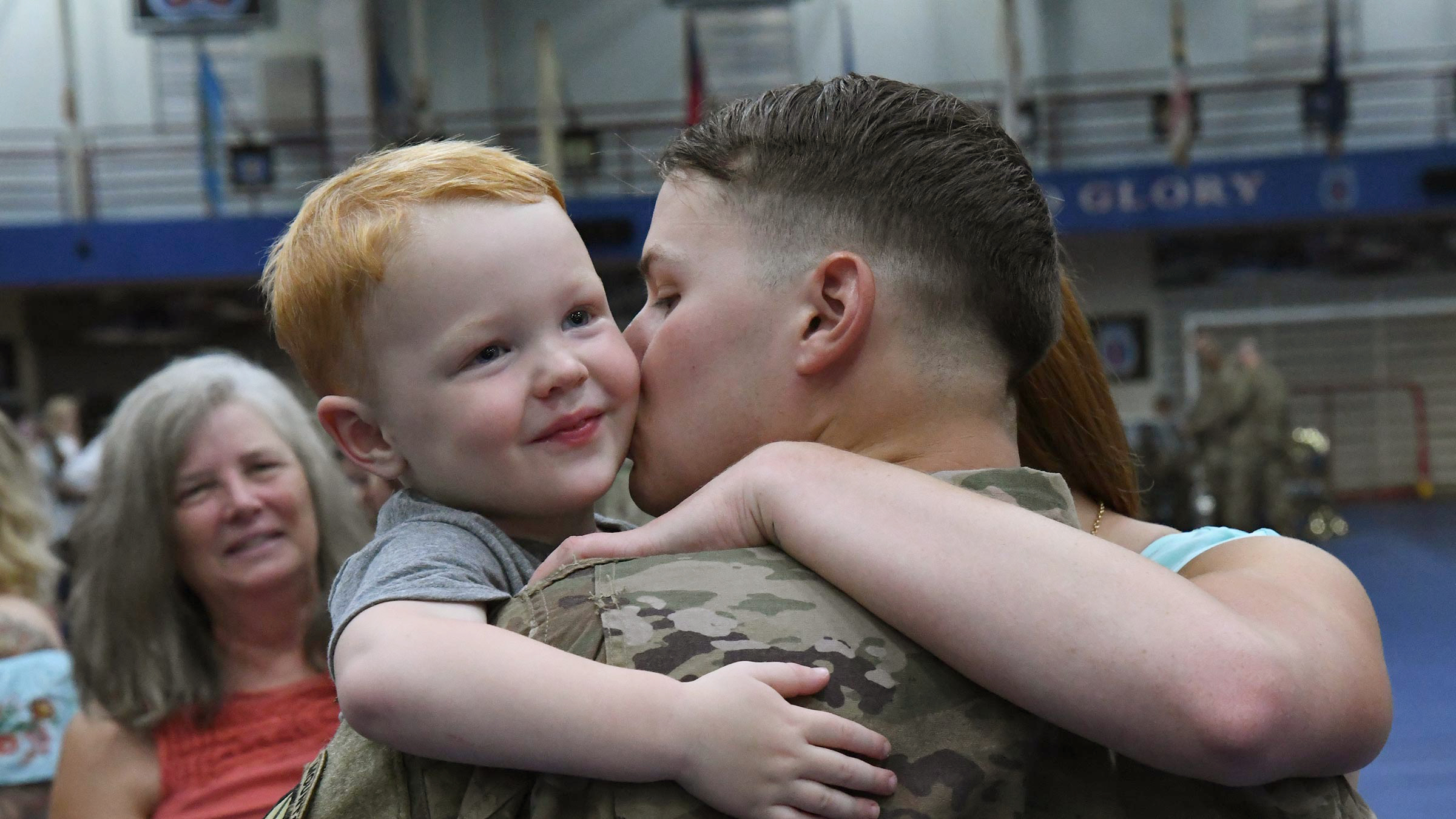 Service member embraces son.