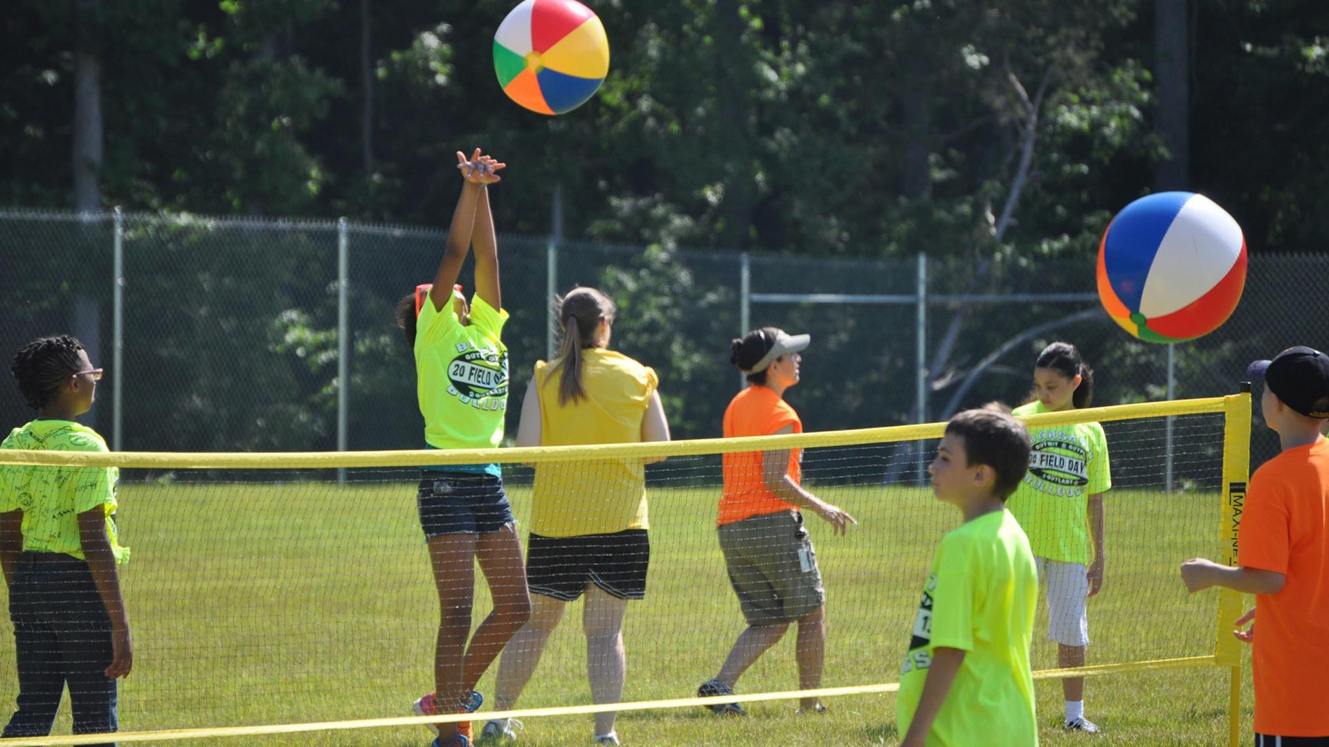Youth playing volleyball outside