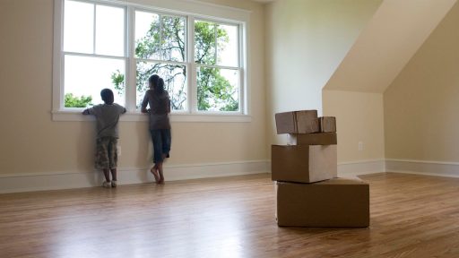 Children in new home with moving boxes
