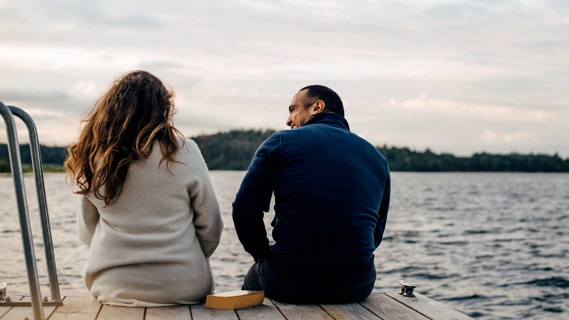 Married couple talking on dock