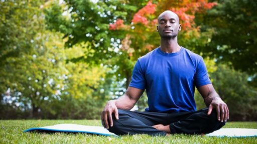 man in park practicing yoga