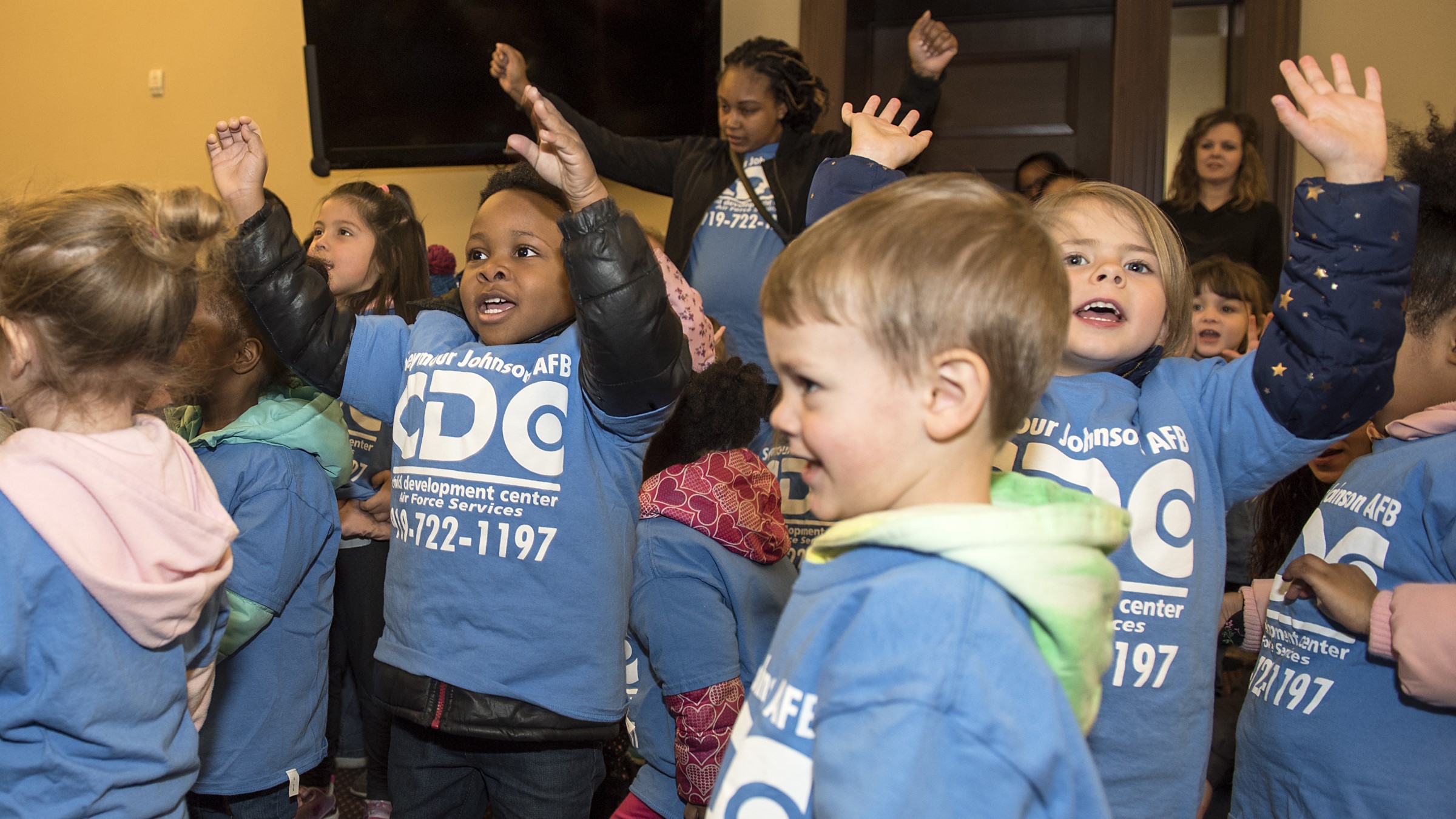 Preschoolers sing at a child development center