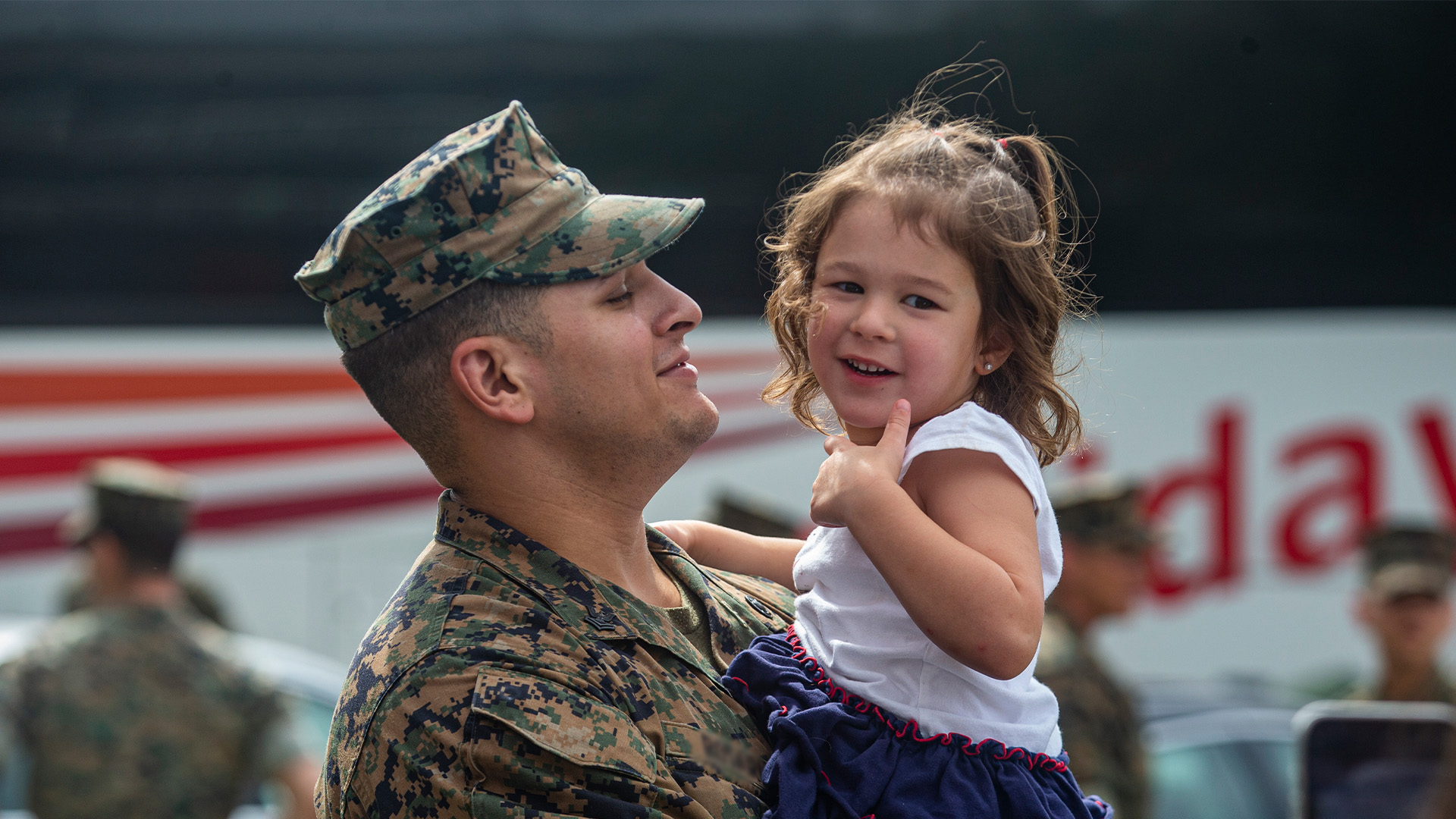 Marine father holds daughter