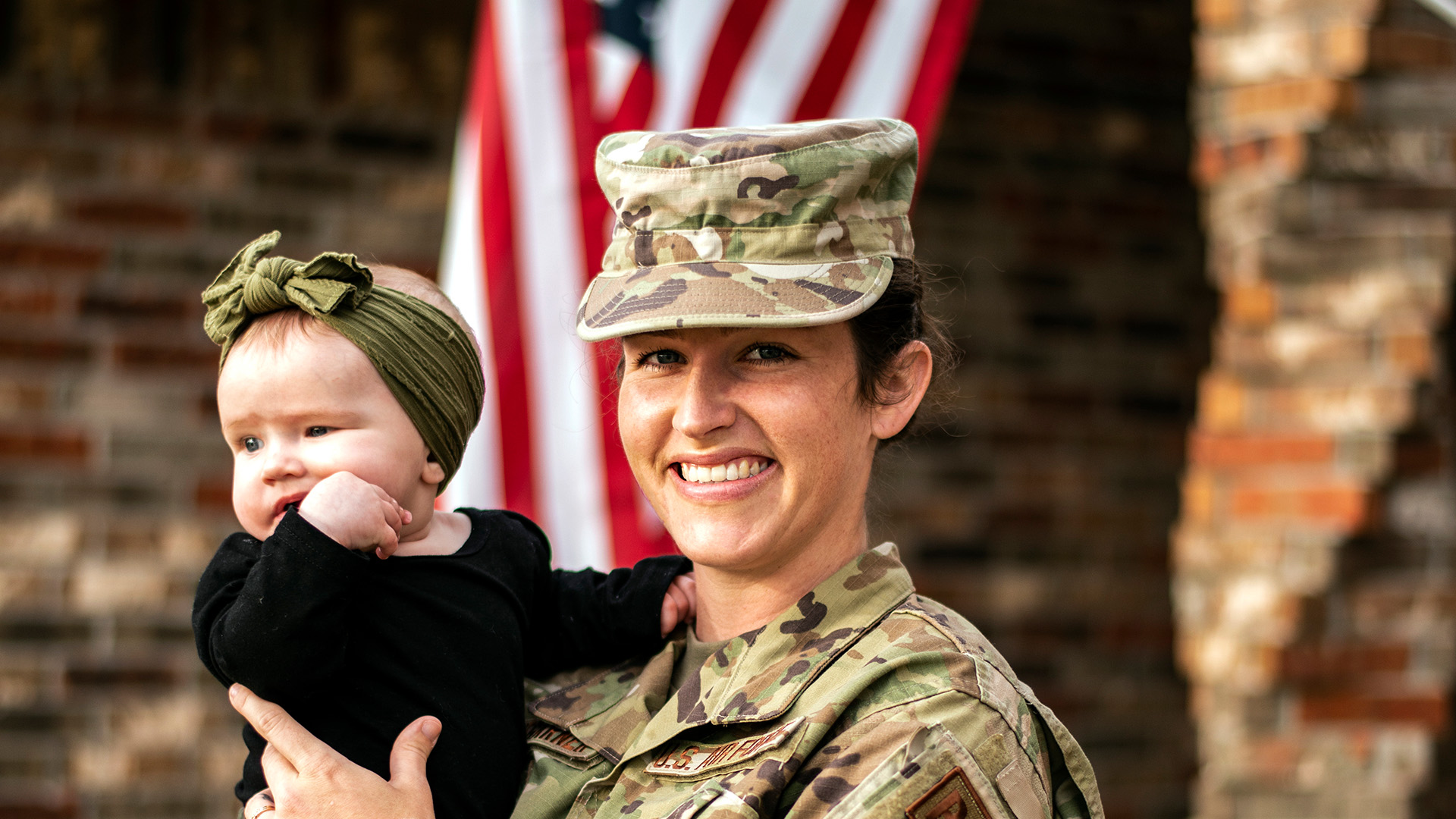 A military mom holds her baby girl