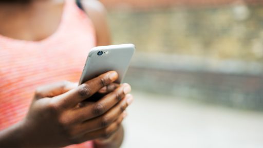 A woman dials a cell phone