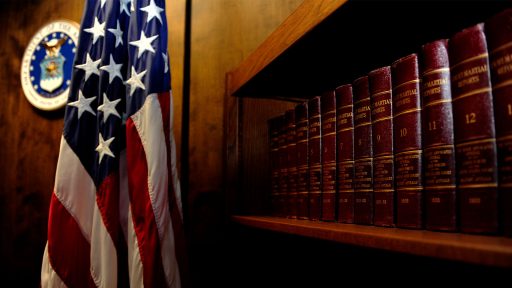 American flag next to bookshelf