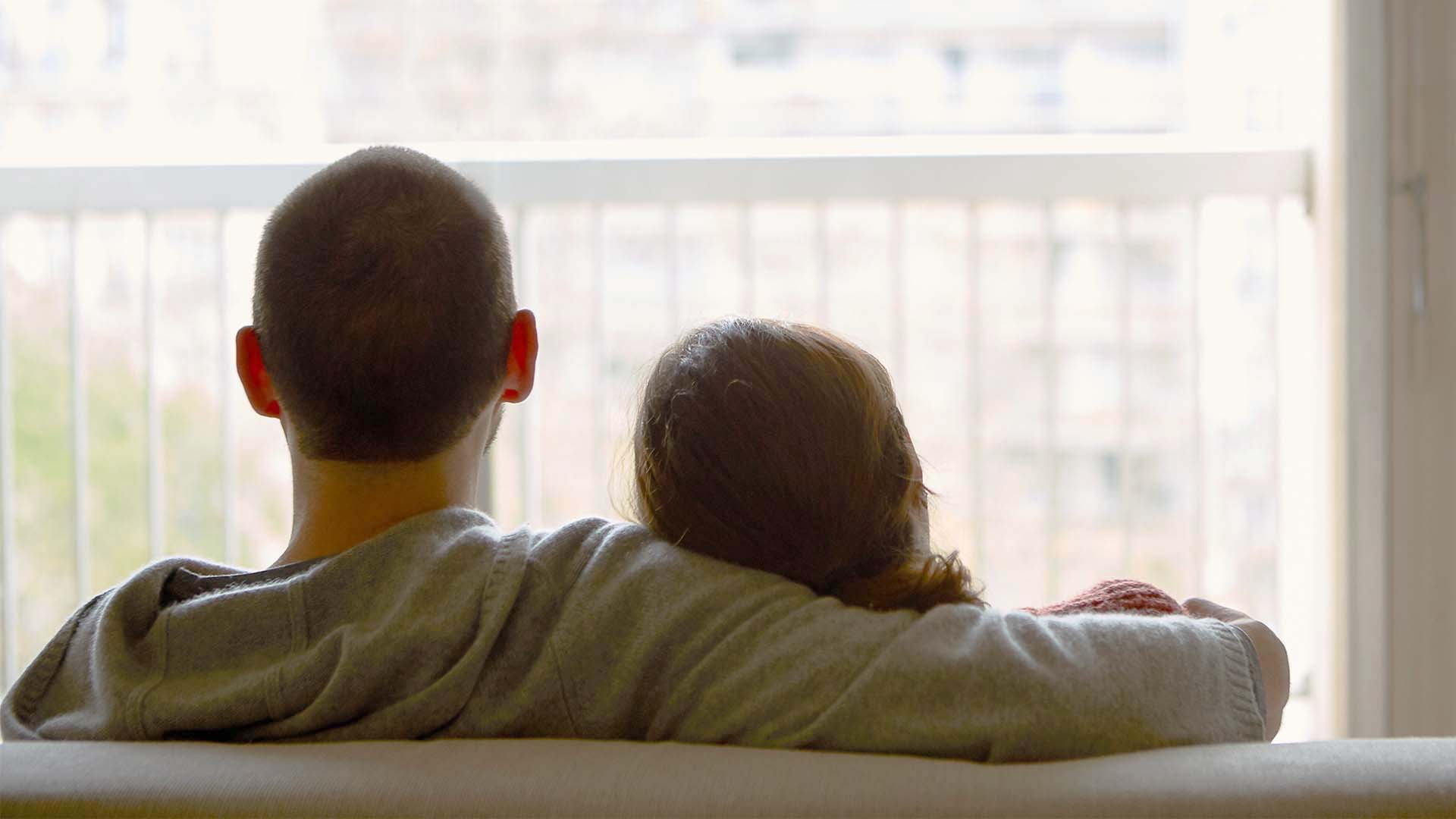couple sitting together looking out window