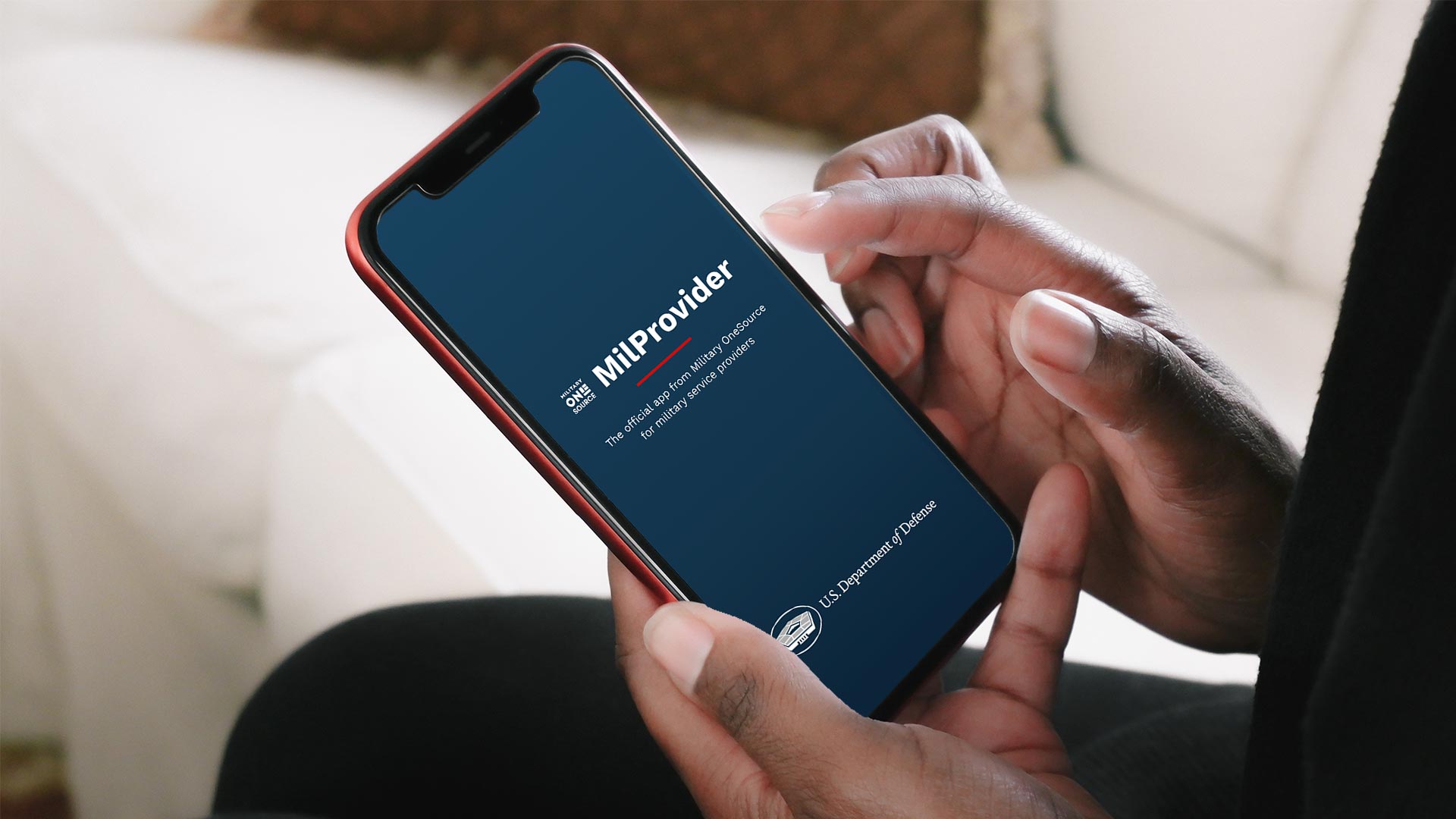 Hands holding mobile phone accessing MilProvider app