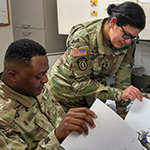 Two soldiers looking at paperwork
