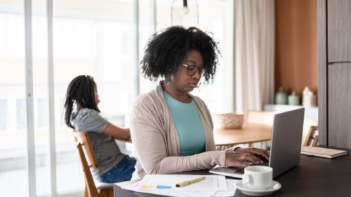 woman typing on computer at home