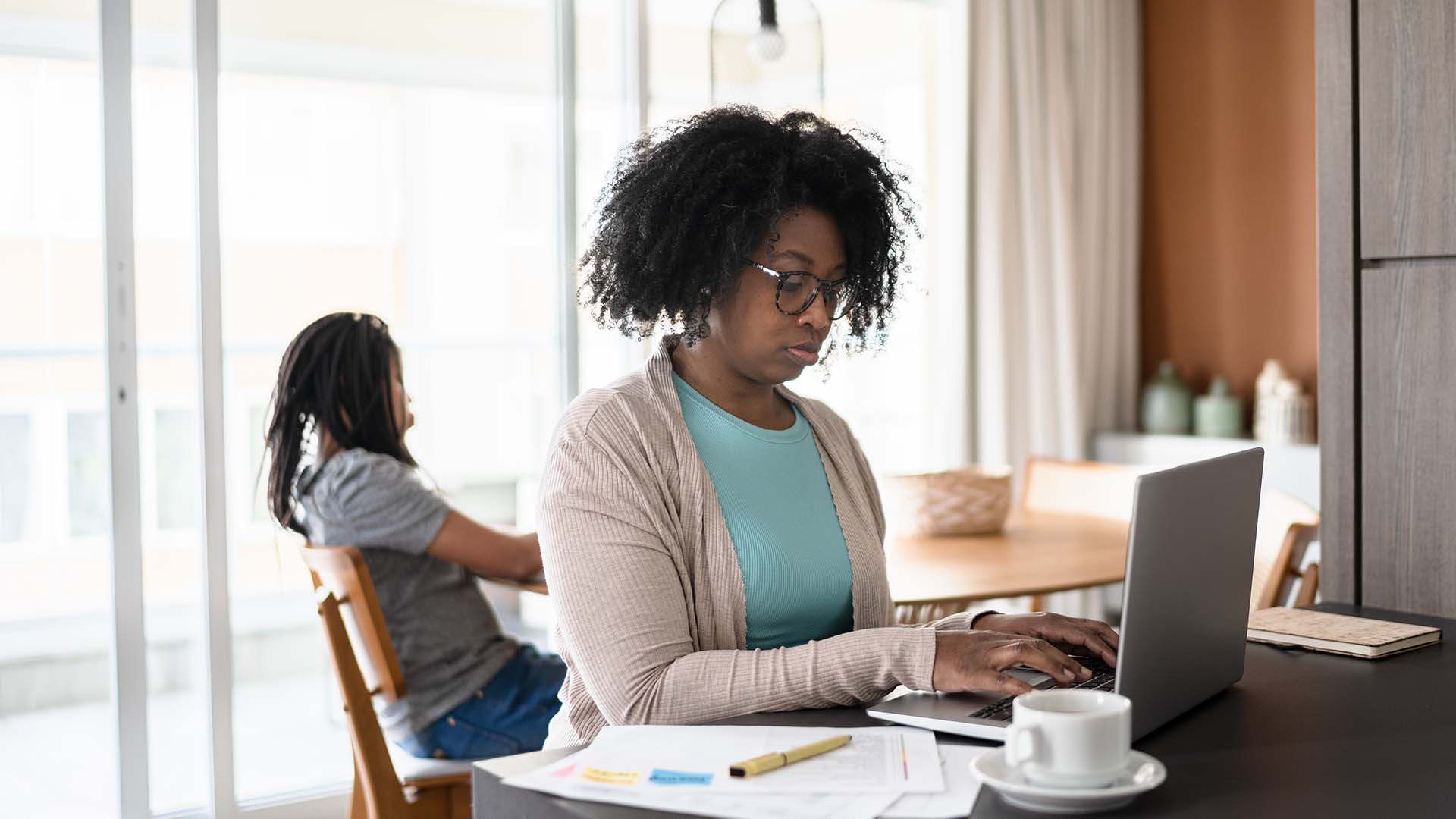 woman typing on computer at home