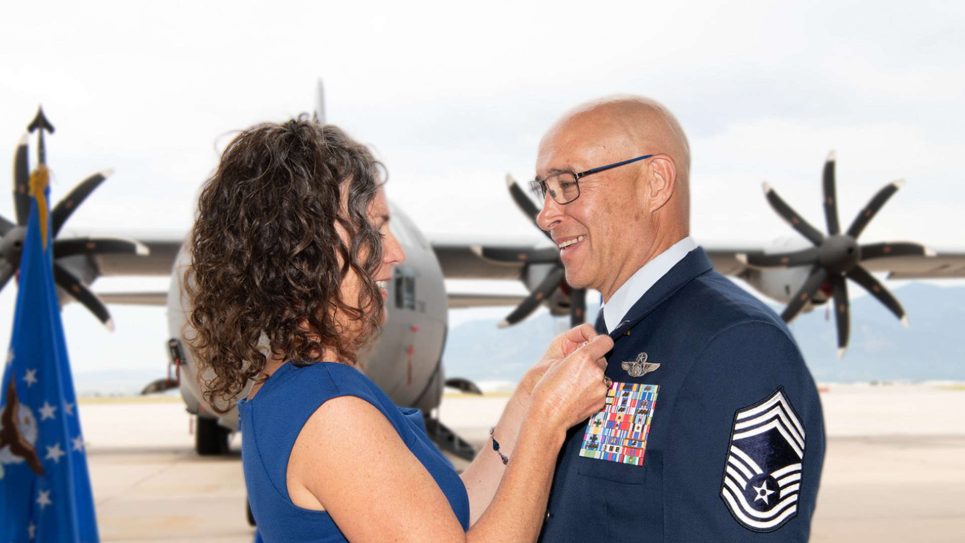 service member receives retirement pin from wife